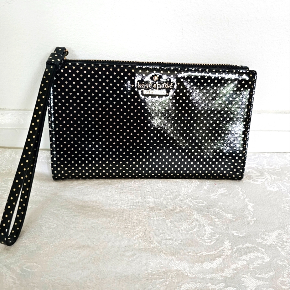 Kate Spade Shiny Black and Gold Polka Dot Wristlet with Storybook Lining…
